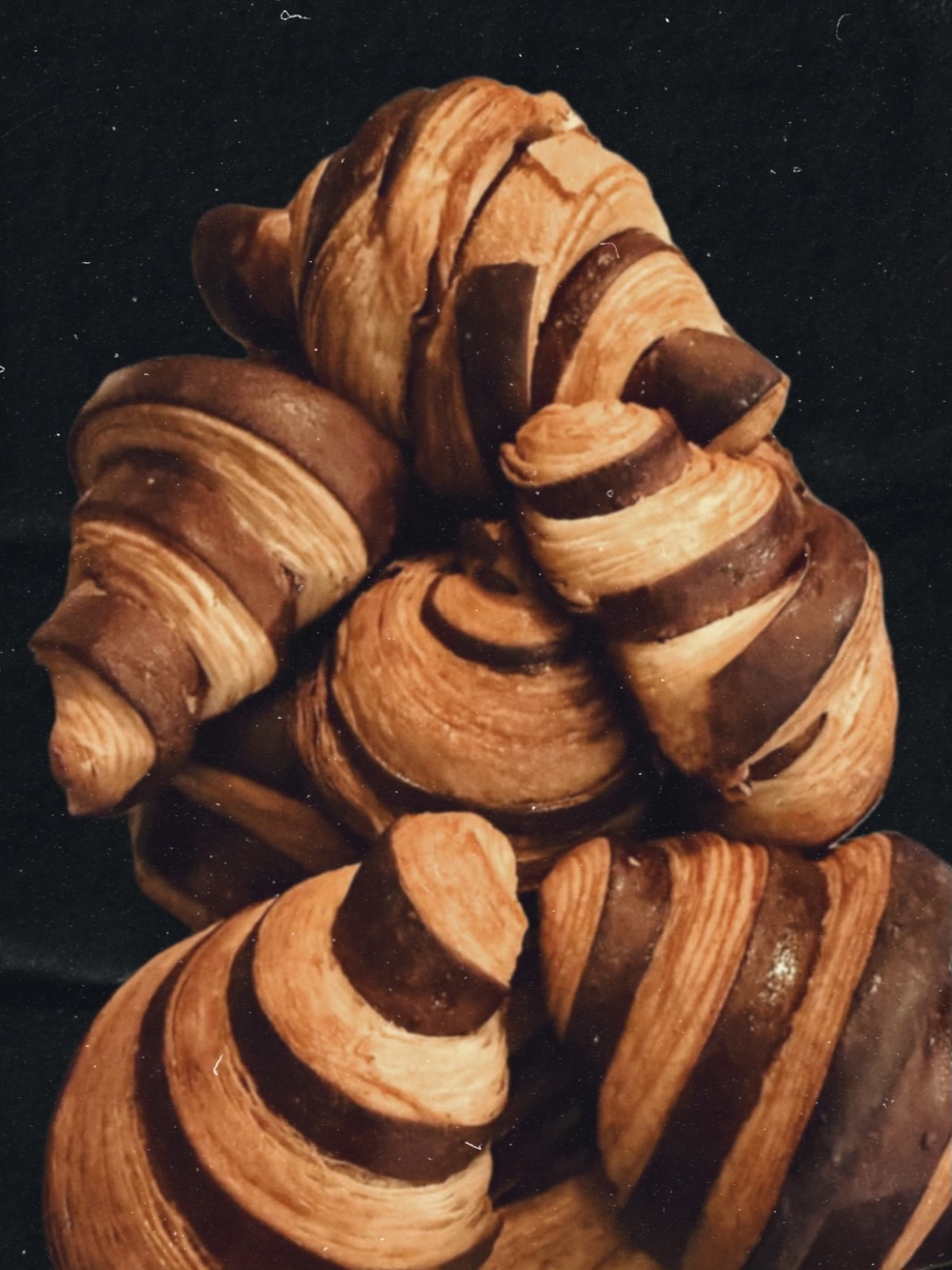 Croissants with alternating chocolate and golden pastry layers